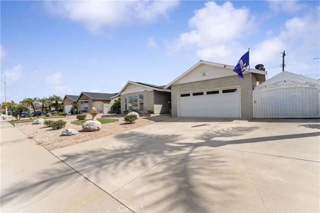 ranch-style home with stucco siding, a gate, concrete driveway, and a garage