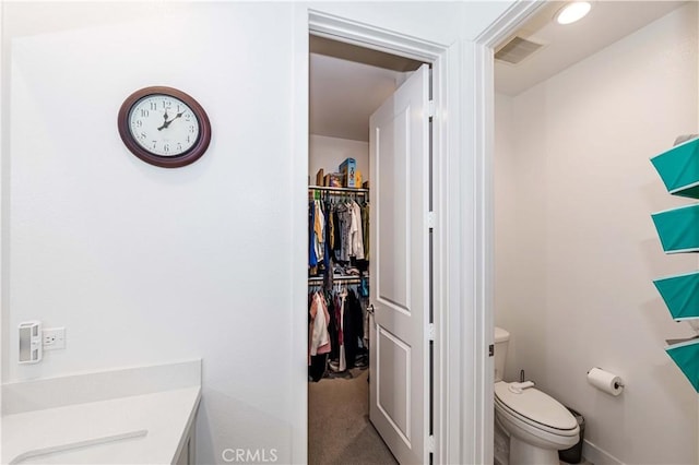 14161 Olivia Ct, La Mirada, CA 90638 - bathroom with a walk in closet, visible vents, toilet, and baseboards