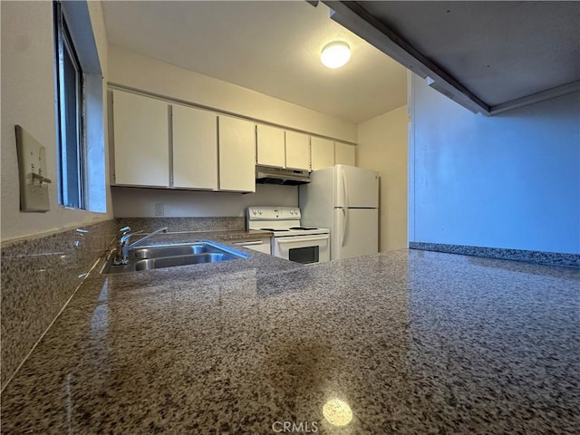 kitchen with white cabinets, a sink, under cabinet range hood, and white appliances