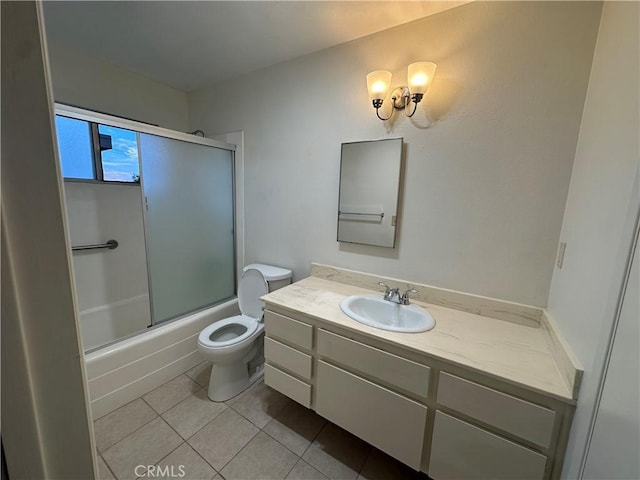 full bathroom with vanity, toilet, tile patterned flooring, and combined bath / shower with glass door