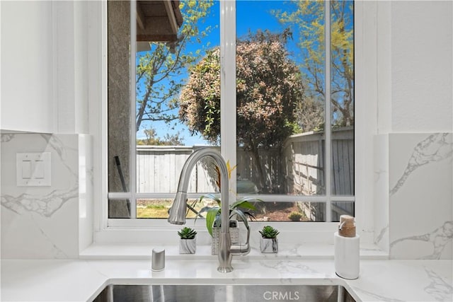 11891 Ramsdell Ct, San Diego, CA 92131 - room details with a sink, white cabinetry, and light stone countertops
