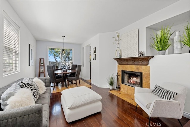 11891 Ramsdell Ct, San Diego, CA 92131 - living room with a tile fireplace, wood finished floors, and baseboards