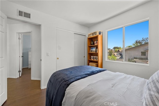 11891 Ramsdell Ct, San Diego, CA 92131 - bedroom with baseboards, a closet, visible vents, and dark wood-type flooring
