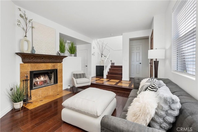 11891 Ramsdell Ct, San Diego, CA 92131 - living area with baseboards, a tiled fireplace, wood finished floors, and stairway