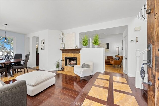 11891 Ramsdell Ct, San Diego, CA 92131 - living area featuring baseboards, dark wood finished floors, and a tiled fireplace