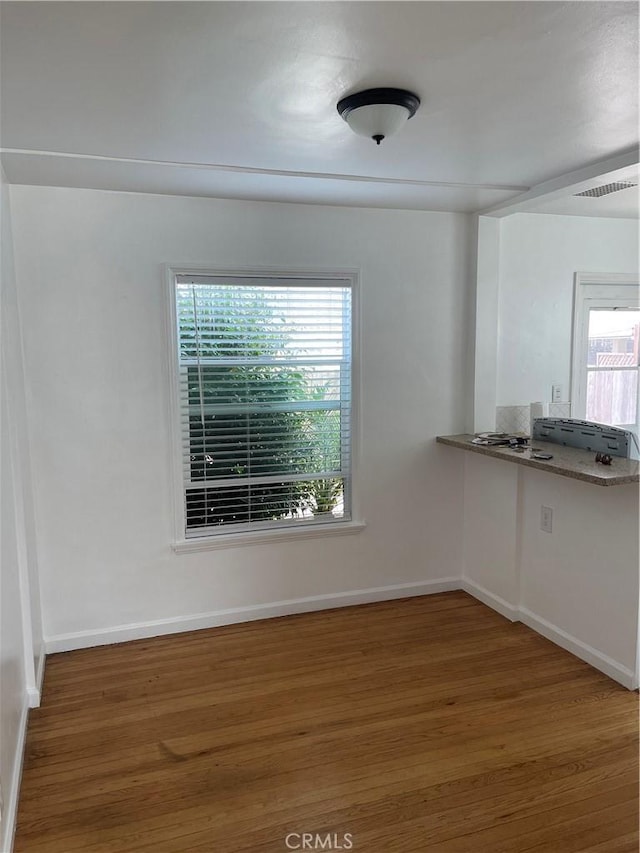 258 Glendora Ave, Long Beach, CA 90803 - unfurnished dining area featuring plenty of natural light, wood finished floors, visible vents, and baseboards