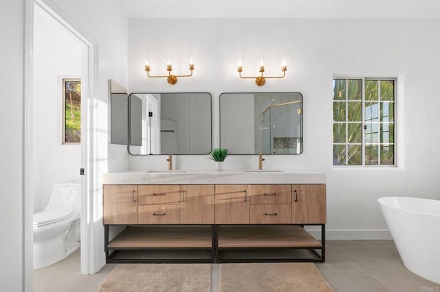 full bath with double vanity, a sink, toilet, and a shower stall