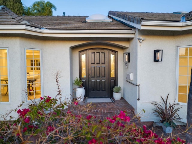 doorway to property with stucco siding