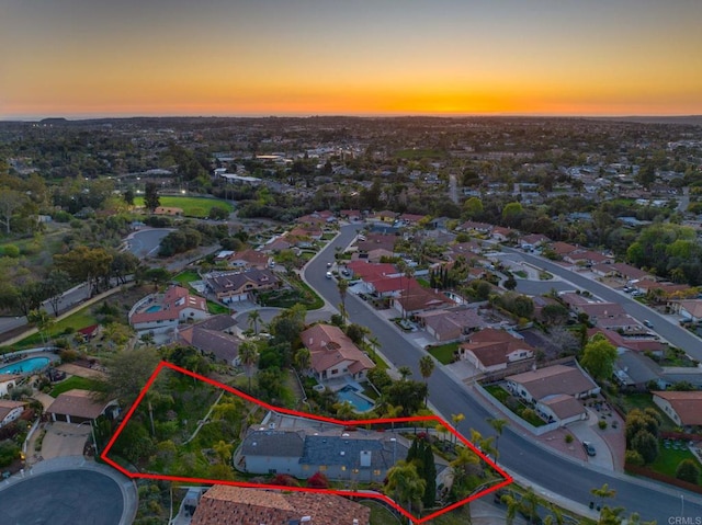 aerial view at dusk featuring a residential view