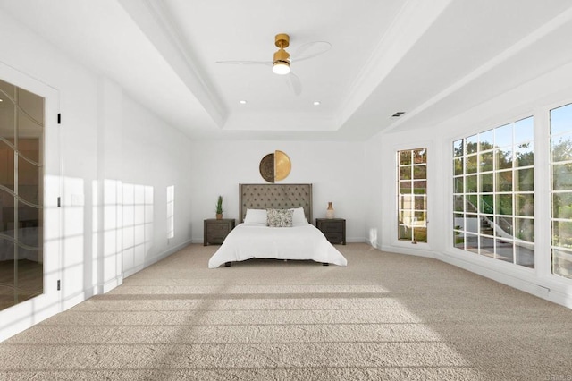 bedroom with baseboards, carpet floors, visible vents, and a raised ceiling