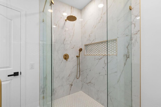 full bathroom featuring a marble finish shower