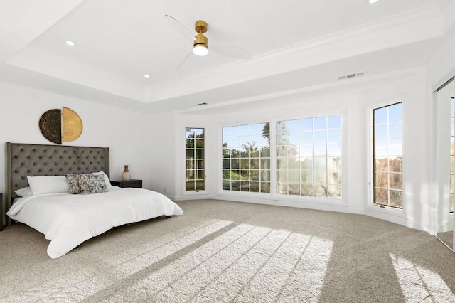 bedroom featuring visible vents, carpet, ornamental molding, recessed lighting, and a tray ceiling