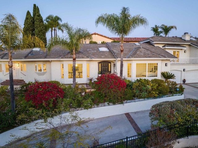 view of front of home featuring stucco siding and a garage