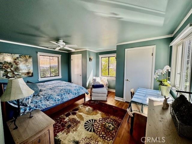 28019 N Shore Rd, Lake Arrowhead, CA 92352 - bedroom with wood finished floors, crown molding, lofted ceiling, ceiling fan, and two closets
