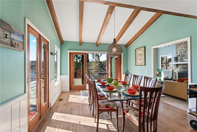 28019 N Shore Rd, Lake Arrowhead, CA 92352 - dining room featuring wainscoting, wood-type flooring, and a decorative wall