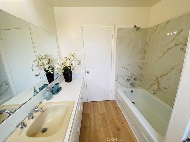 bathroom with vanity,  shower combination, and wood finished floors