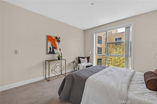 bedroom featuring baseboards and carpet
