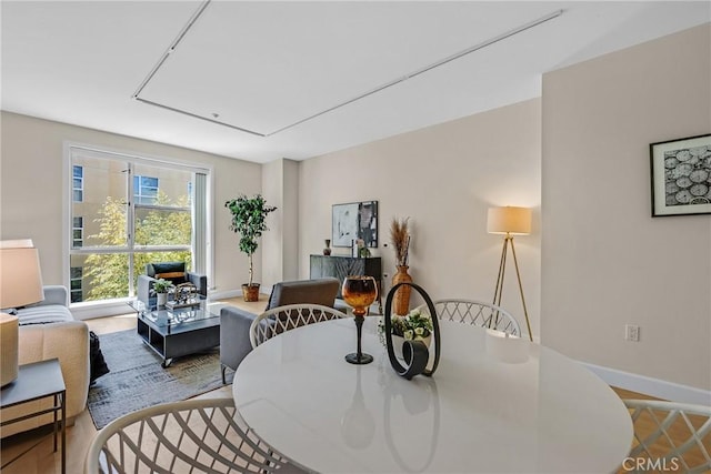 dining area with attic access and baseboards