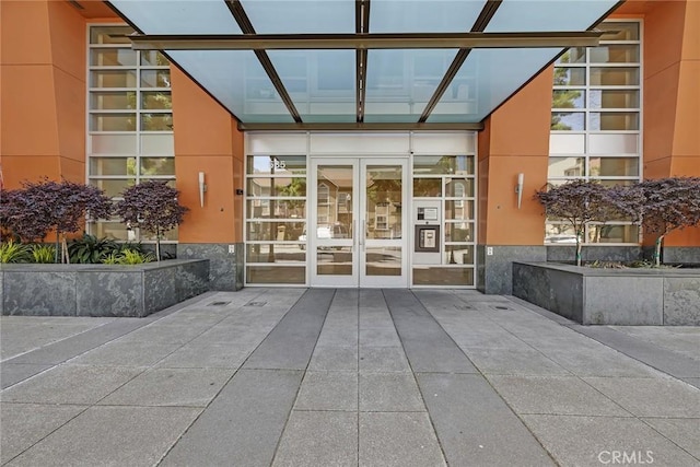 585 9th St Unit 556, Oakland, CA 94607 - view of exterior entry featuring stone siding, french doors, and stucco siding