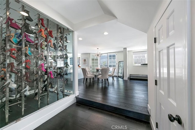dining space with wood-type flooring, recessed lighting, and a chandelier