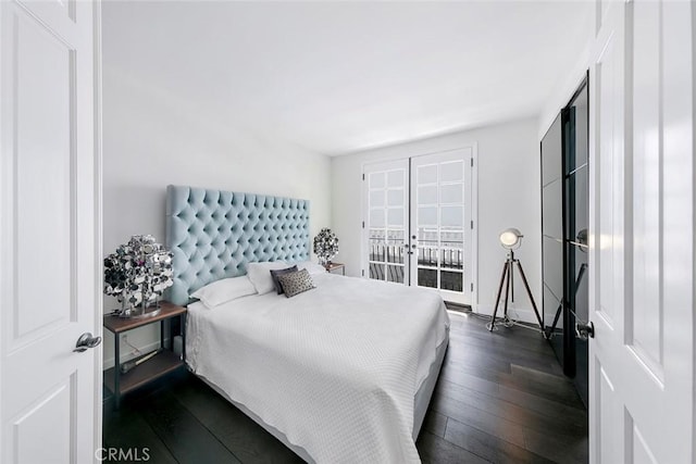 bedroom featuring french doors and dark wood-style floors