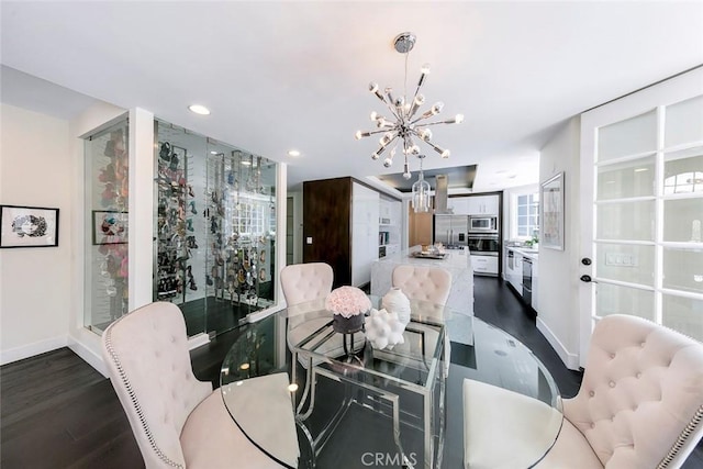 dining space with a chandelier, dark wood-type flooring, baseboards, and recessed lighting