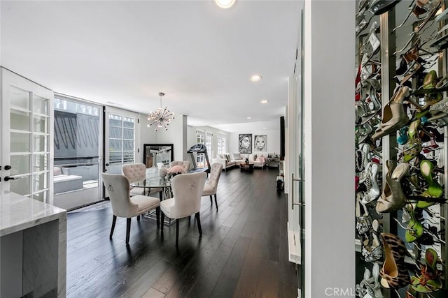 dining room featuring an inviting chandelier, dark wood finished floors, and recessed lighting
