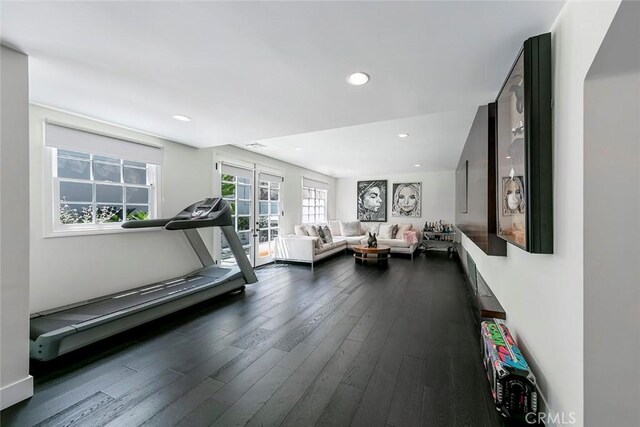 workout room with dark wood finished floors and recessed lighting