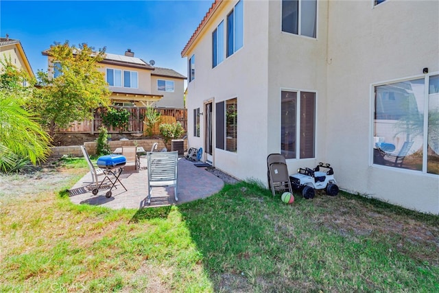 view of yard with a patio, fence, and central AC