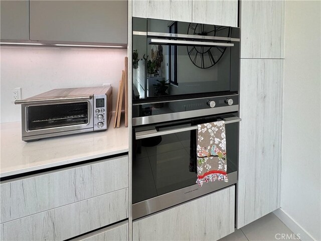 57601 Santo Thomas Ln, Quinta, CA 92253 - kitchen with a toaster, modern cabinets, double wall oven, and light countertops