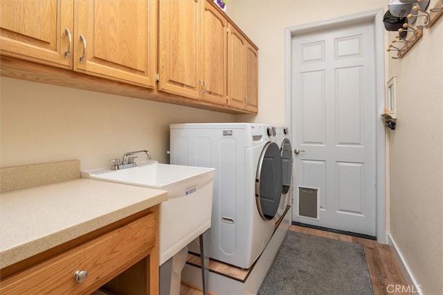 45500 Right Rd, Ahwahnee, CA 93601 - washroom with separate washer and dryer, light wood-style flooring, cabinet space, and baseboards