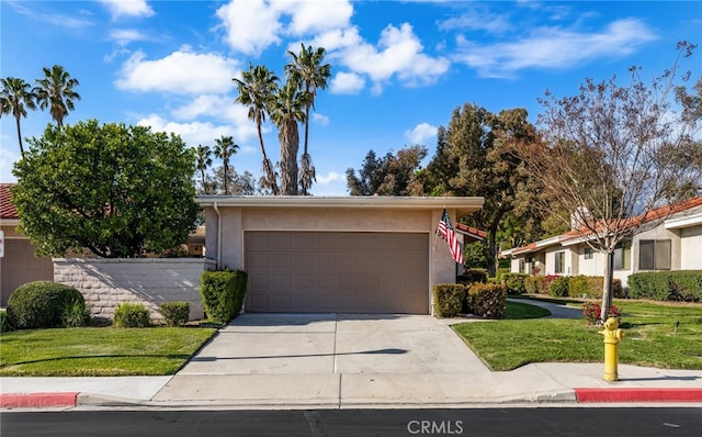 1021 Pebble Beach Dr, Upland, CA 91784 - view of front of home featuring stucco siding, concrete driveway, a front yard, and a garage