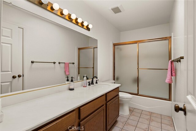 1021 Pebble Beach Dr, Upland, CA 91784 - bathroom featuring tile patterned flooring, vanity, toilet, and shower / bath combination with glass door