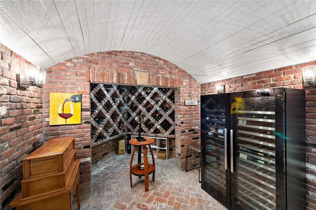 6 Via Presea, Coto De Caza, CA 92679 - wine room with brick wall, wine cooler, brick flooring, and lofted ceiling