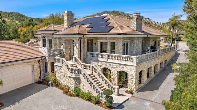 6 Via Presea, Coto De Caza, CA 92679 - view of front of house with a chimney, stone siding, solar panels, and a tiled roof