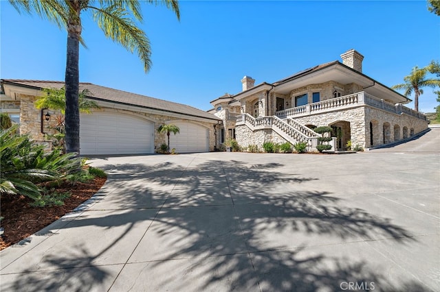 6 Via Presea, Coto De Caza, CA 92679 - view of front of property with stone siding, concrete driveway, a chimney, and a garage