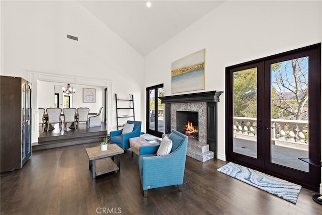 6 Via Presea, Coto De Caza, CA 92679 - living room featuring high vaulted ceiling, a chandelier, french doors, wood finished floors, and a warm lit fireplace
