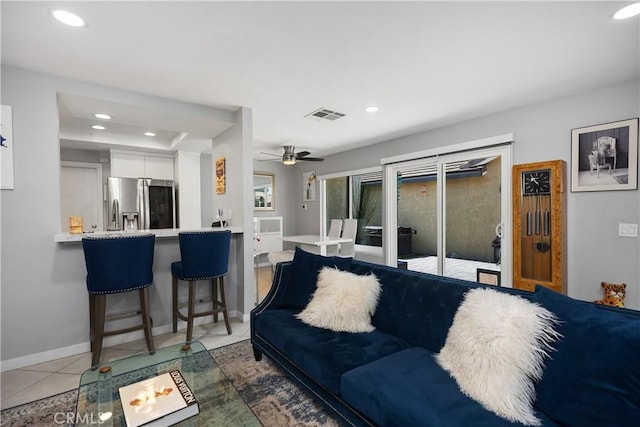 living area with ceiling fan, baseboards, tile patterned flooring, visible vents, and recessed lighting