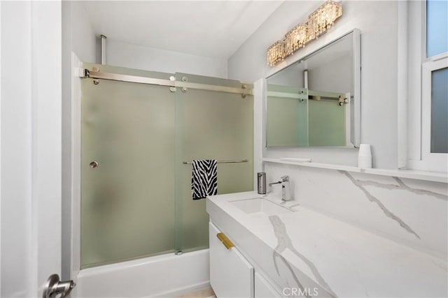 bathroom with vanity and enclosed tub / shower combo
