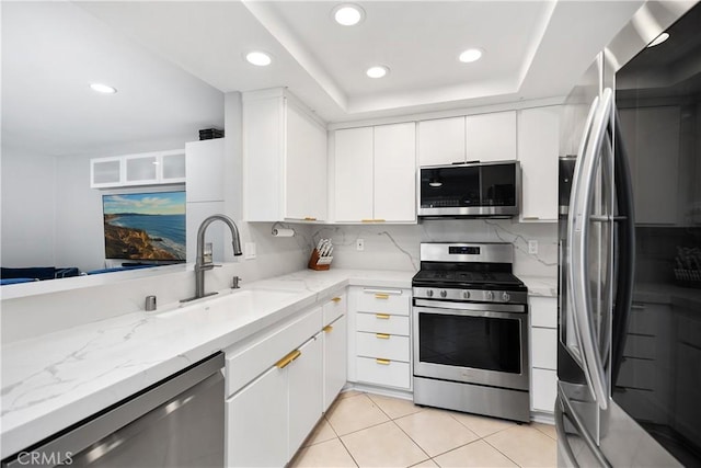 kitchen with white cabinets, stainless steel appliances, and recessed lighting
