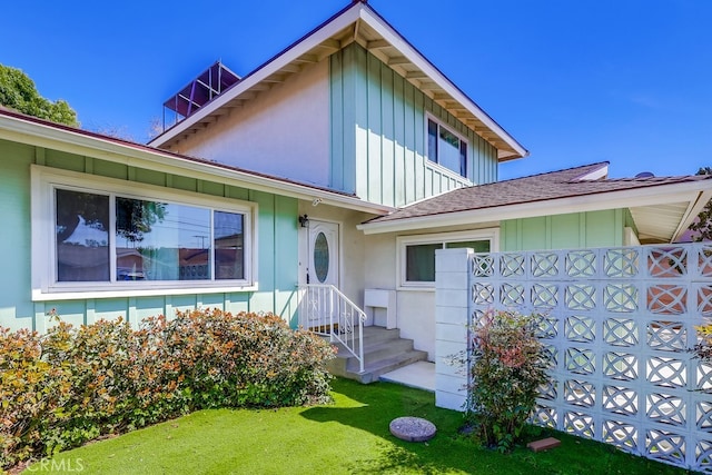 view of front facade featuring board and batten siding and a front lawn