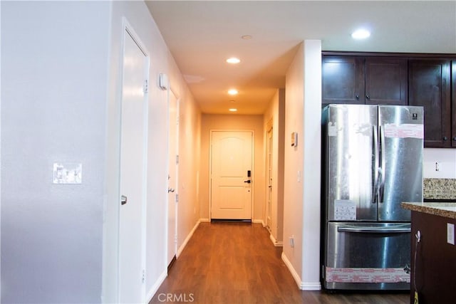 hallway featuring dark wood-style flooring, baseboards, and recessed lighting