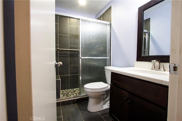 full bath with vanity, toilet, a shower stall, and tile patterned flooring