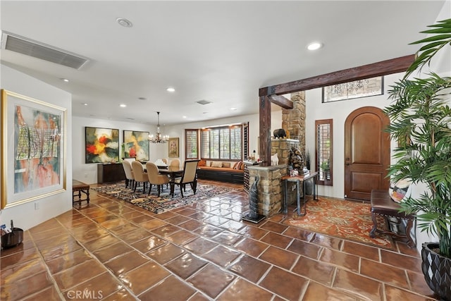 tiled living area with visible vents, an inviting chandelier, and recessed lighting