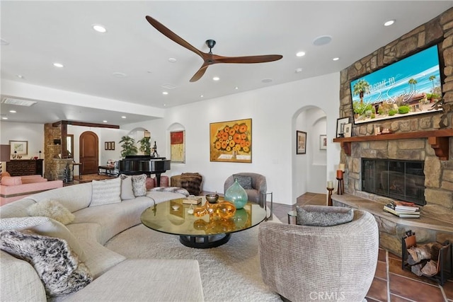 living room featuring arched walkways, visible vents, ceiling fan, and recessed lighting