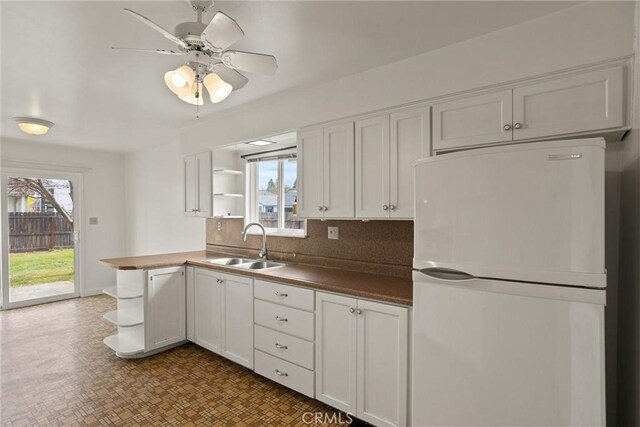 2909 Carlene Pl, Chico, CA 95973 - kitchen featuring freestanding refrigerator, open shelves, a sink, white cabinetry, and tasteful backsplash