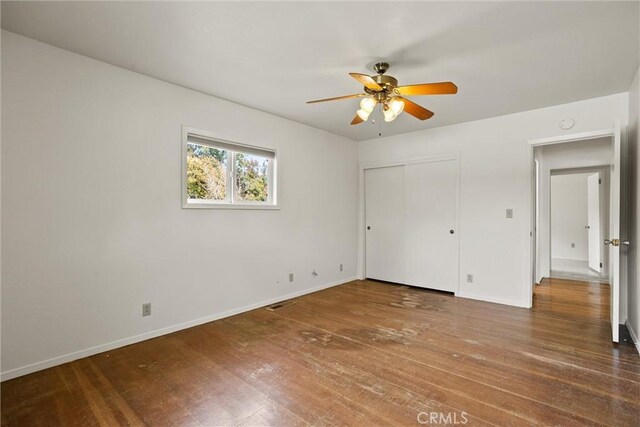 2909 Carlene Pl, Chico, CA 95973 - unfurnished bedroom featuring hardwood / wood-style floors, baseboards, a closet, and a ceiling fan