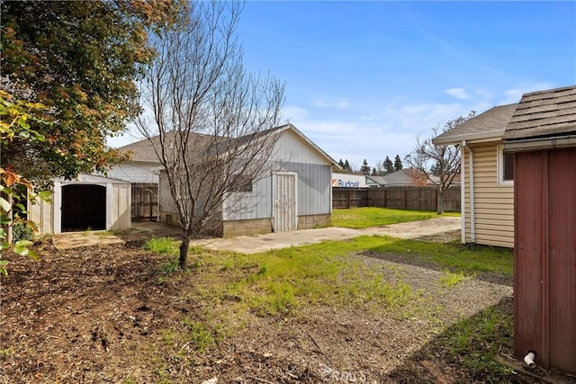 2909 Carlene Pl, Chico, CA 95973 - rear view of house featuring a storage unit, a shingled roof, and an outbuilding