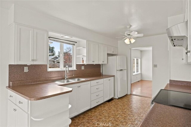 2909 Carlene Pl, Chico, CA 95973 - kitchen featuring a sink, freestanding refrigerator, a ceiling fan, and white cabinetry