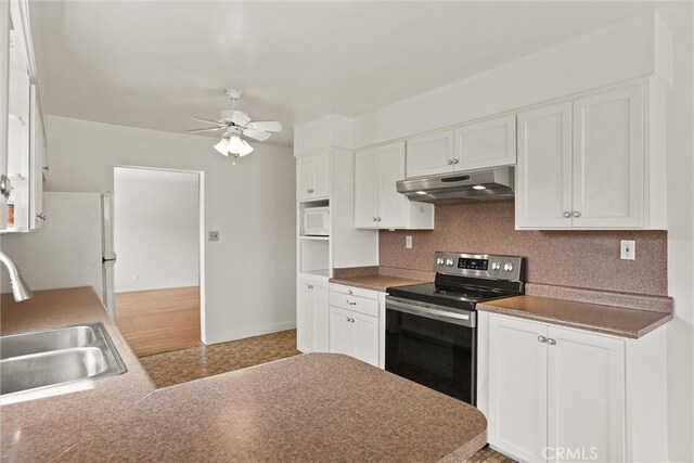 2909 Carlene Pl, Chico, CA 95973 - kitchen featuring under cabinet range hood, white appliances, a sink, and white cabinetry